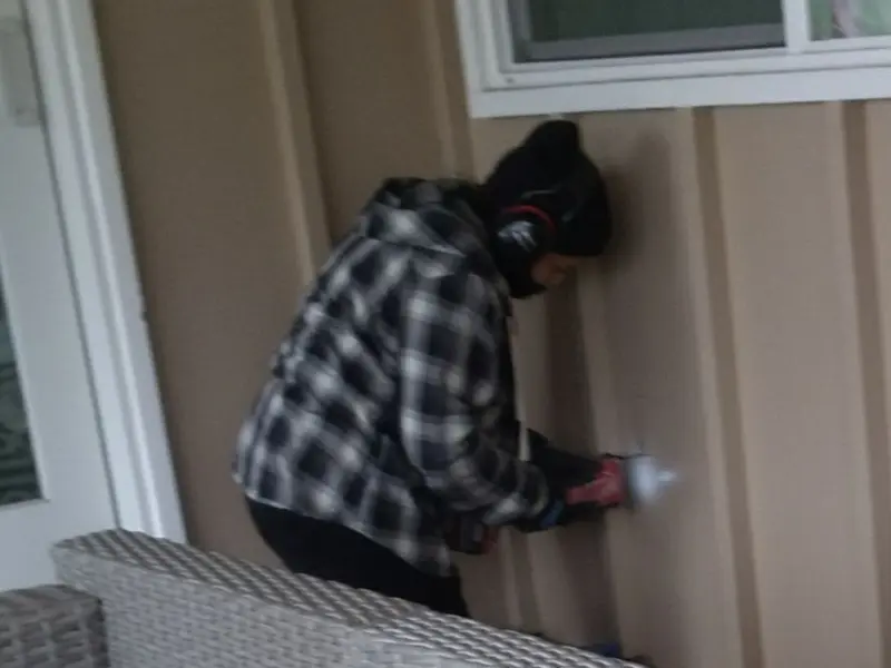 Professional electrician installing an exterior outlet in Tanglewilde